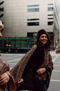 Woman wearing a patterned kani shawl