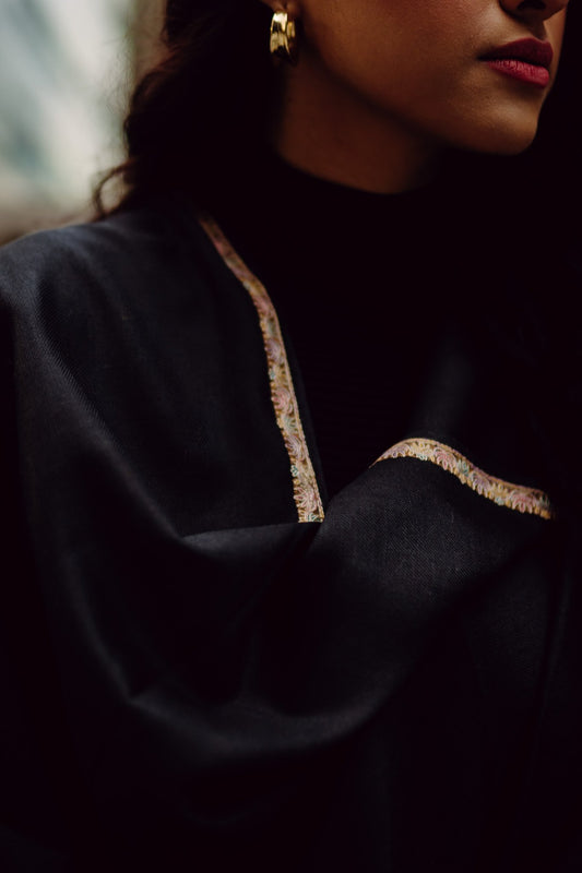 A black mixed wool shawl with golden borders
