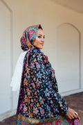 A multi-coloured hand painted and hand embroidered wool shawl