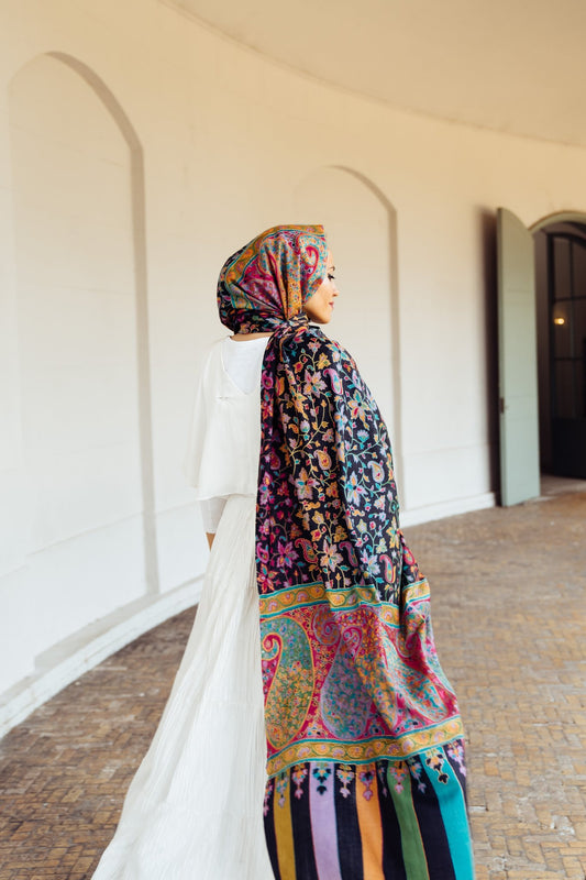 A multi-coloured hand painted and hand embroidered wool shawl